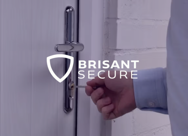 A hand inserts a key into a white door lock, with the Brisant Secure logo.