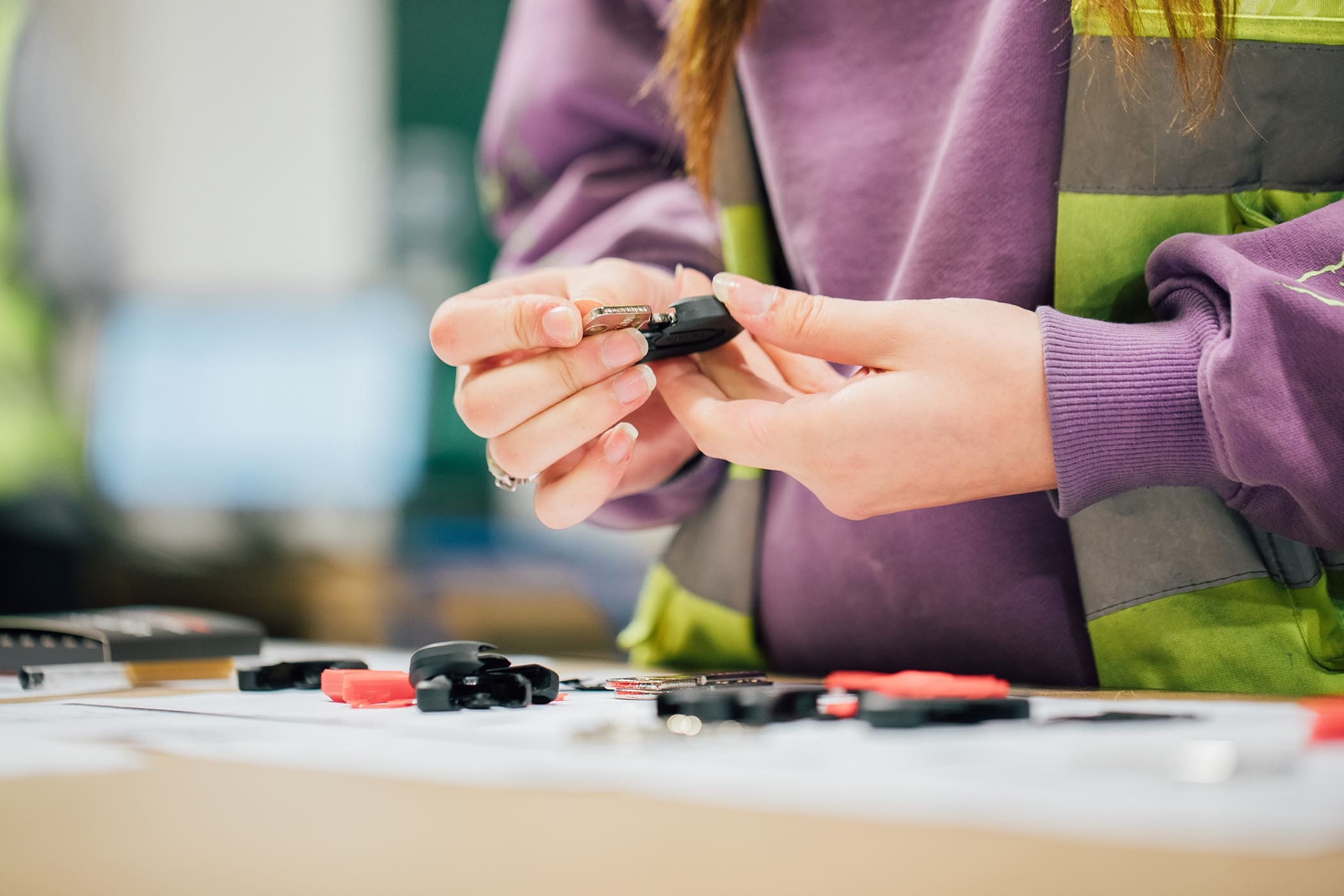 a woman is holding a car key in her hands .