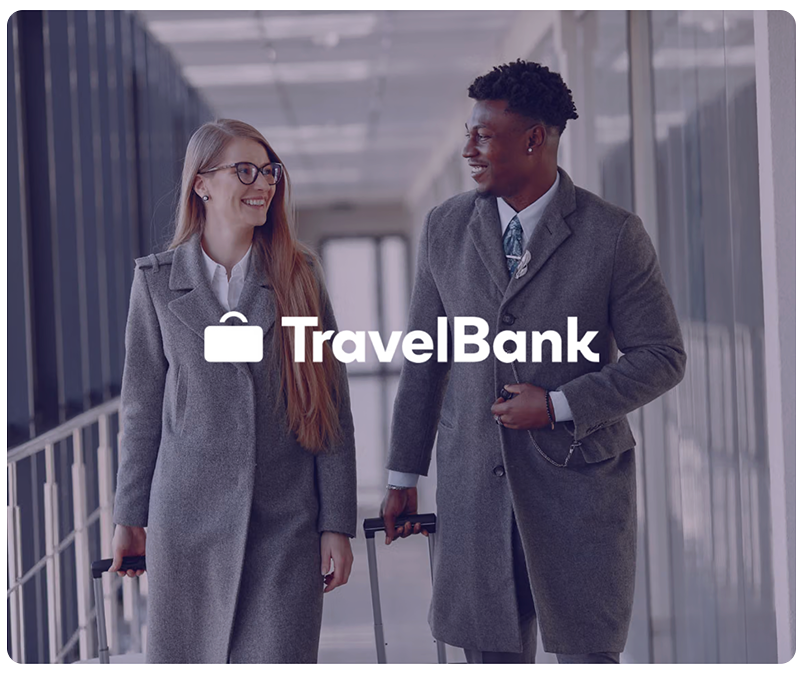 TravelBank logo over two smiling travelers, a man and a woman, walking with suitcases in an airport.