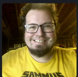 a man wearing glasses and a yellow shirt that says sammies