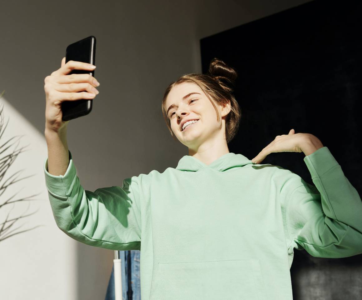 A woman with a phone taking a selfie