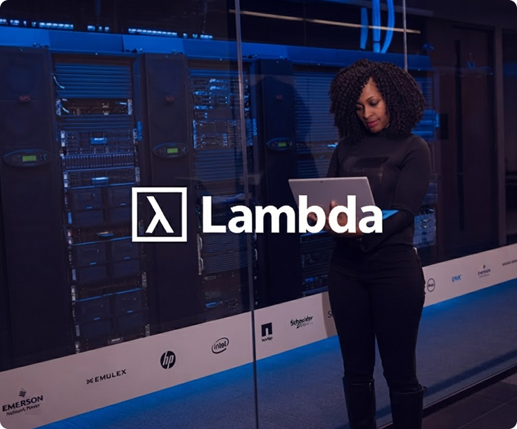 Lambda logo overlaying an image of a woman using a tablet in a data center.