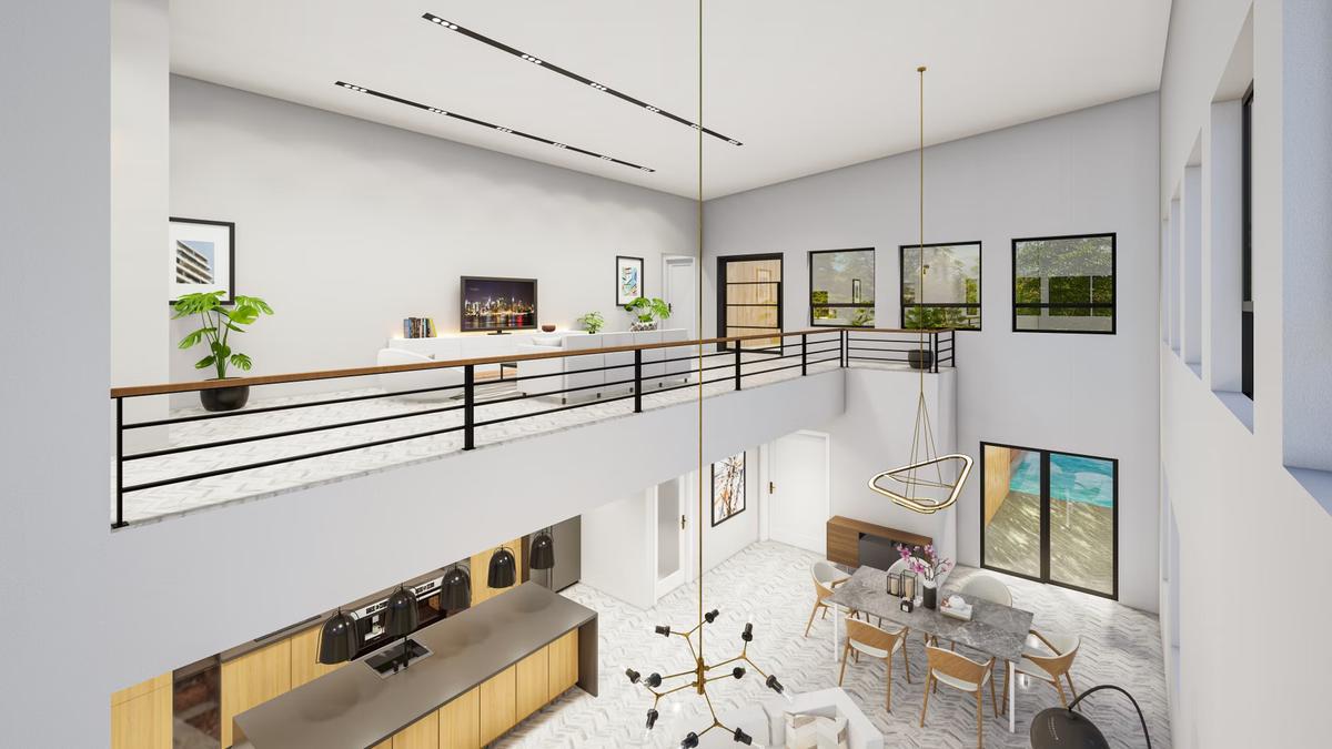 A bright, modern multi-level home interior with a loft living room overlooking a kitchen and dining area.