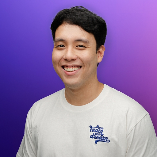 a young man is wearing a white t-shirt with the words `` team on dream '' embroidered on it .