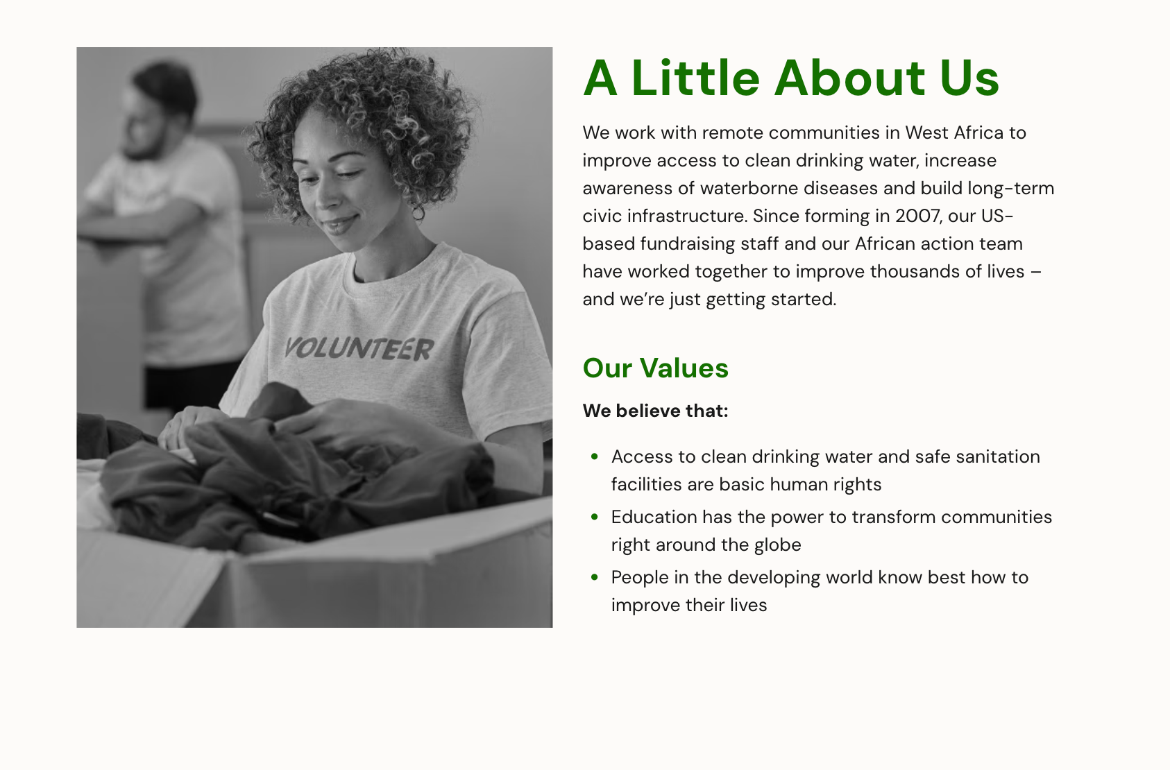 a black and white photo of a woman wearing a volunteer shirt