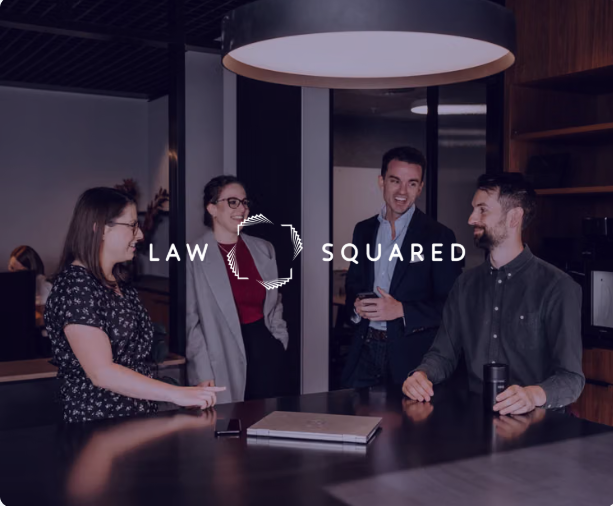 Smiling group in an office with 'LAW SQUARED' logo and text.