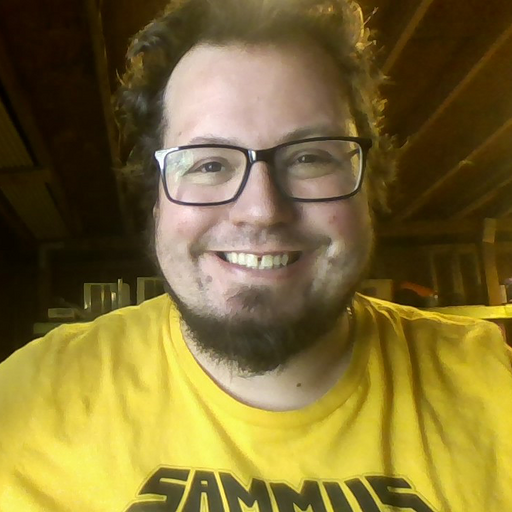 a man wearing glasses and a yellow shirt that says sammies