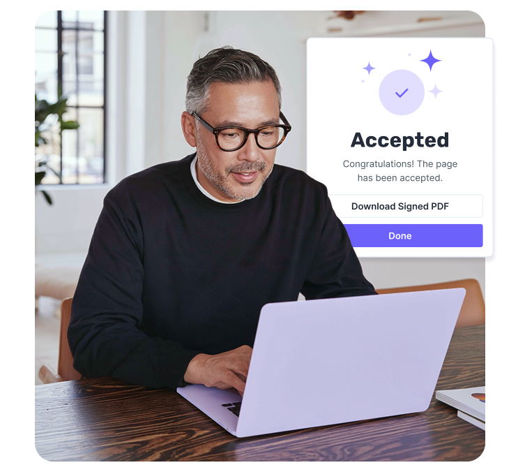 A man using a laptop displaying an "Accepted" confirmation.