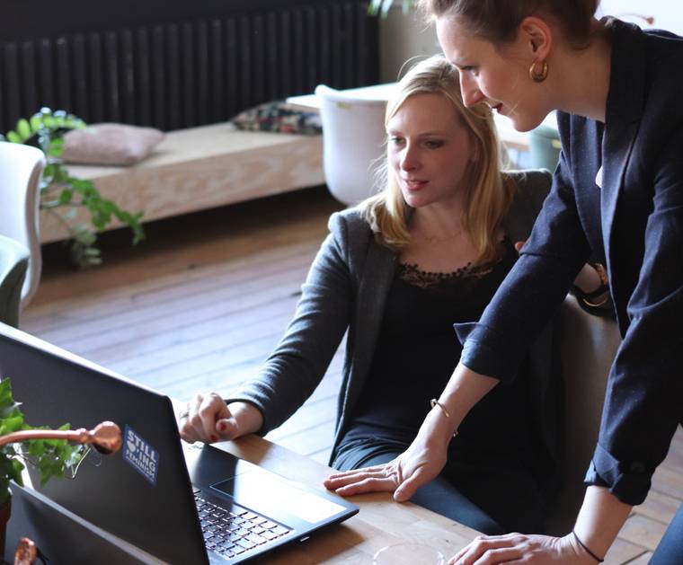 Two women looking at a laptop screen