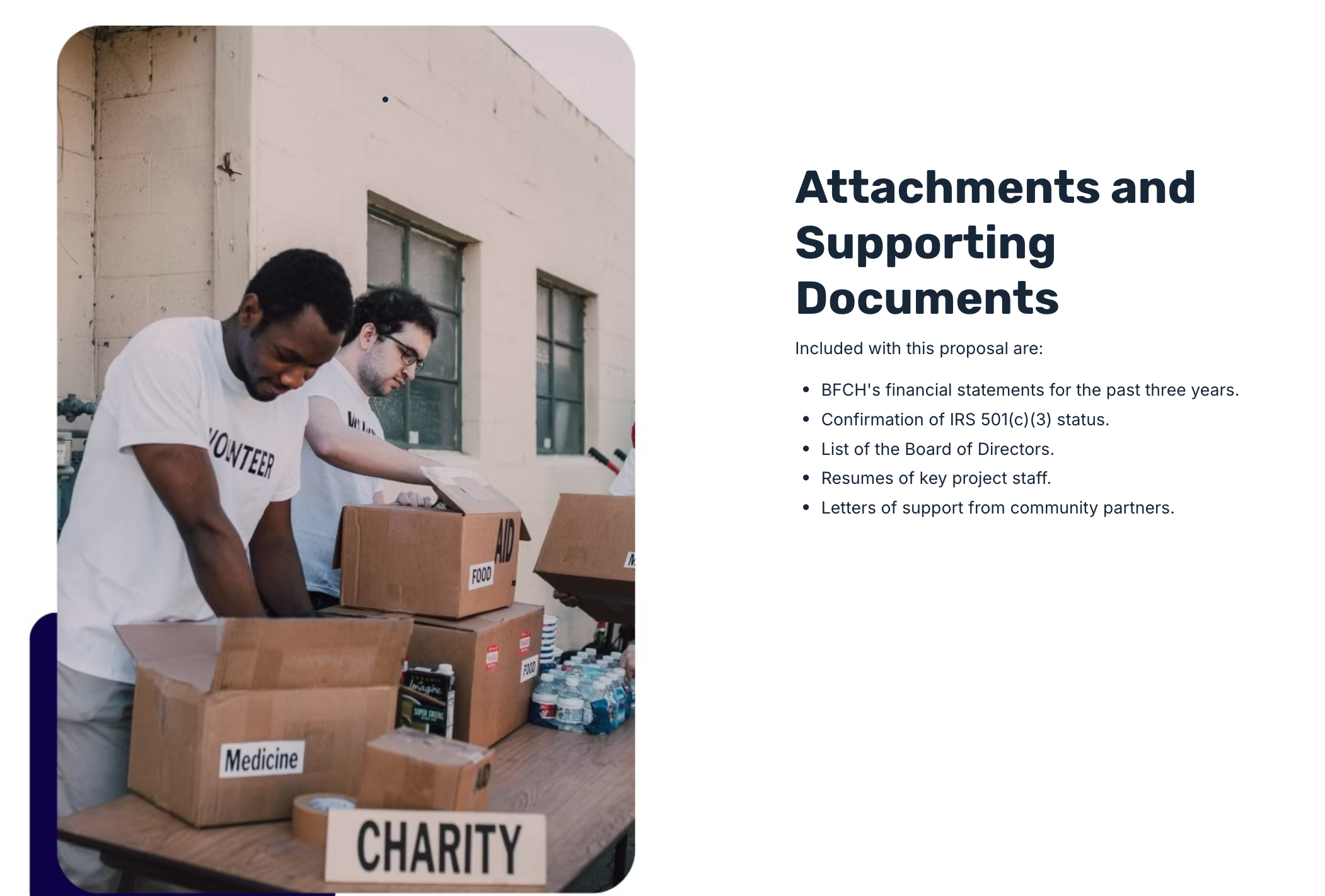 two men in volunteer shirts are packing boxes for charity