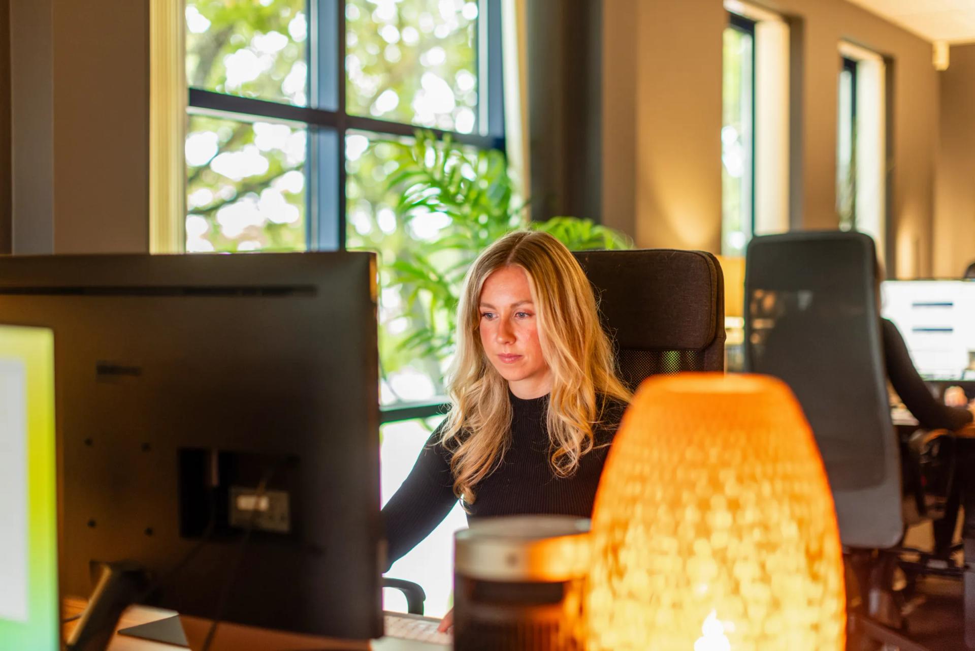 A member of the team working at her desk