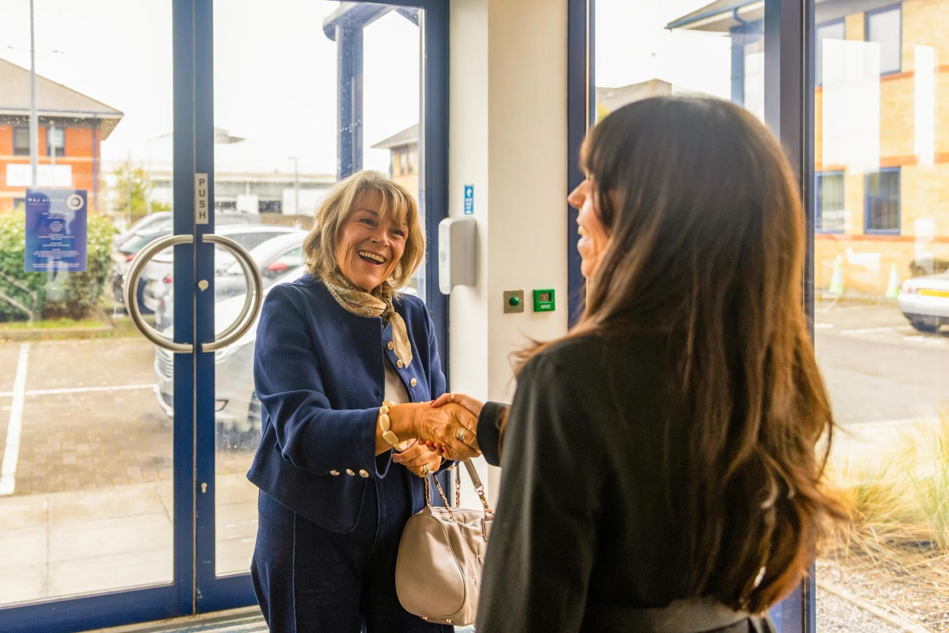 Hannah greeting a visitor at the door