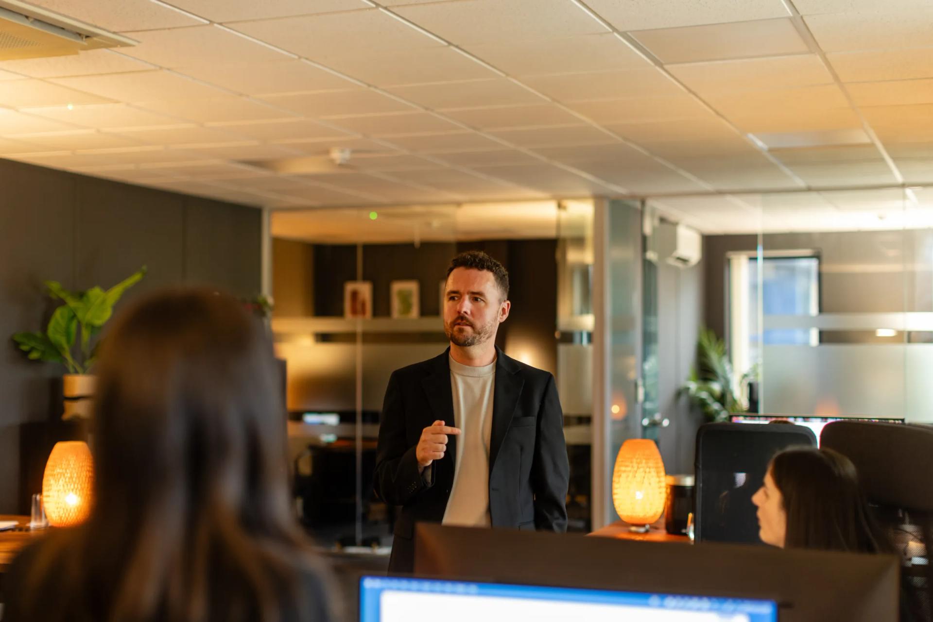 A trainer speaking to a group in the office