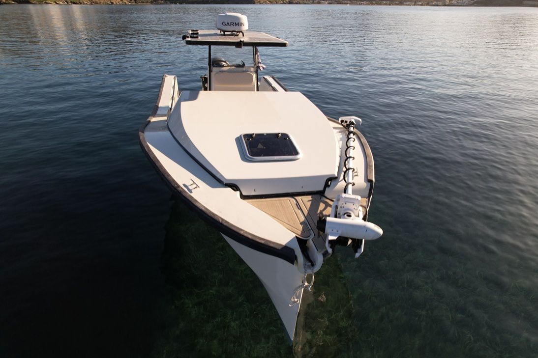 EcoRunner 78 bow-on top-down aerial view, anchored in clear shallow water