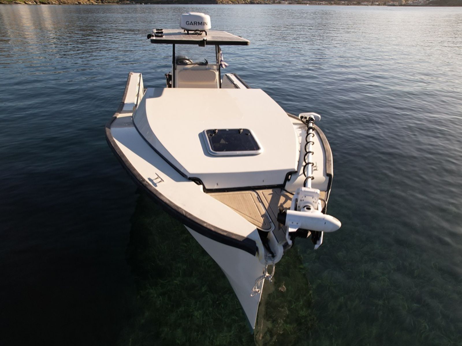 EcoRunner 69 bow-on aerial view at anchor, closed forward hatch, Garmin electric bow motor