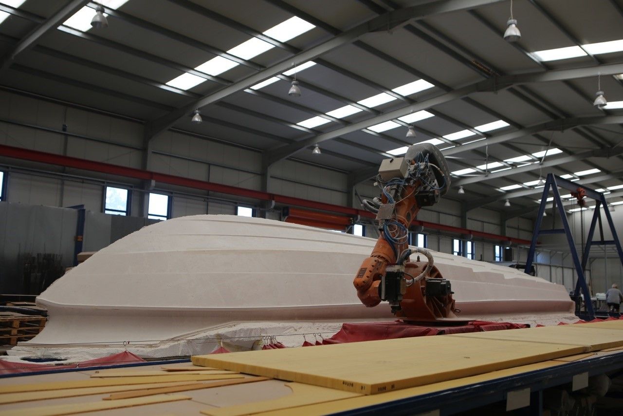 Robotic hull lay-up, single-shot infusion process, TRYGONS composite manufacturing facility