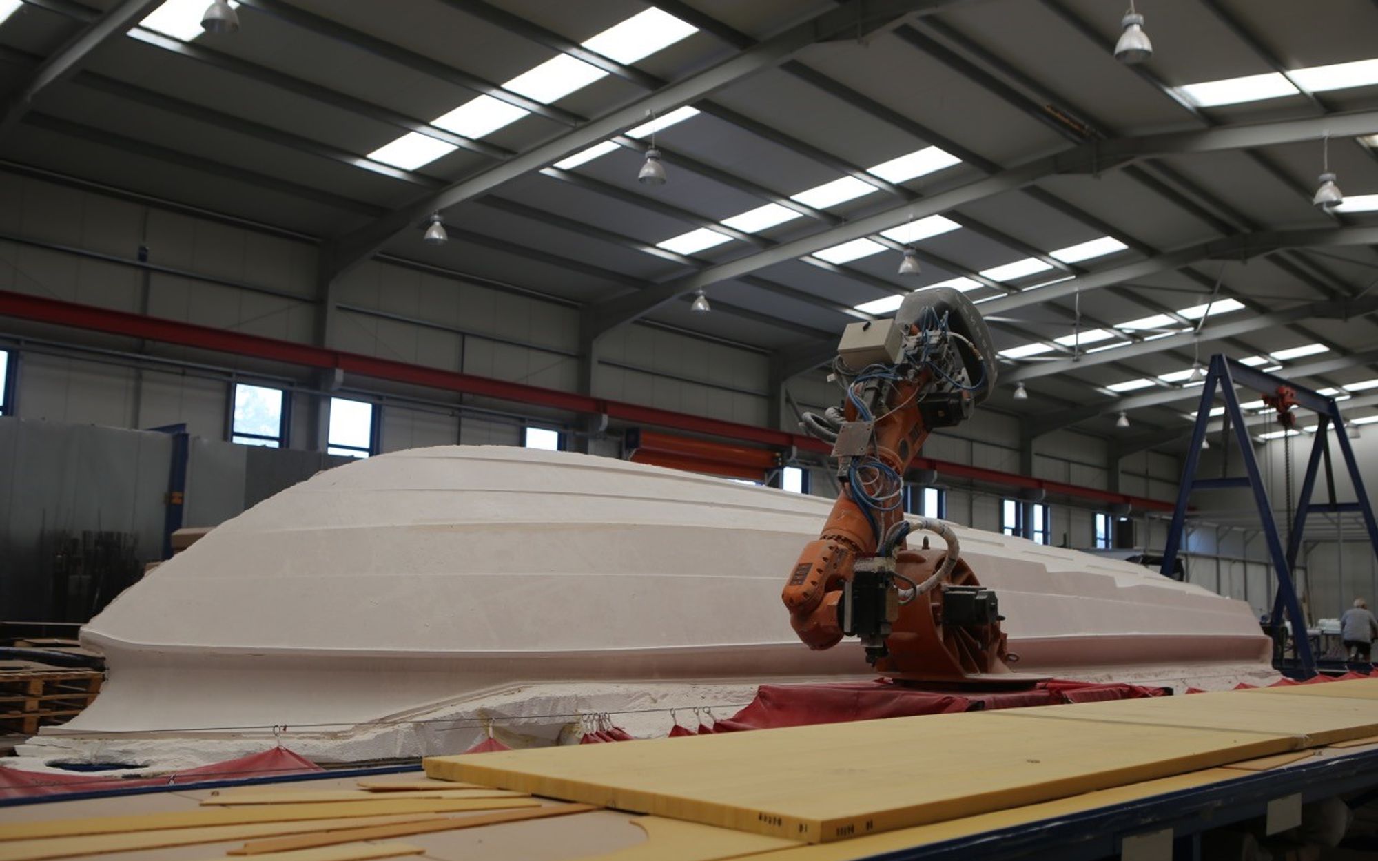 Robotic hull lay-up, single-shot infusion process, TRYGONS composite manufacturing facility