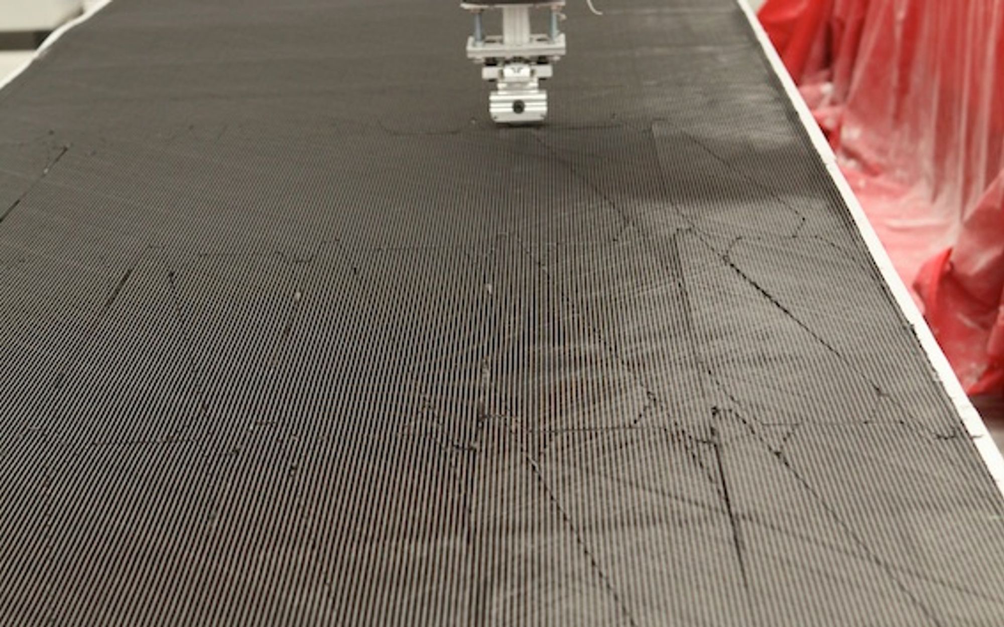 Robotic carbon-fibre ply cutting, TRYGONS composite manufacturing facility