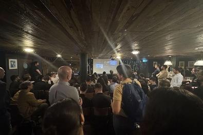 Audience view of the event in the basement.