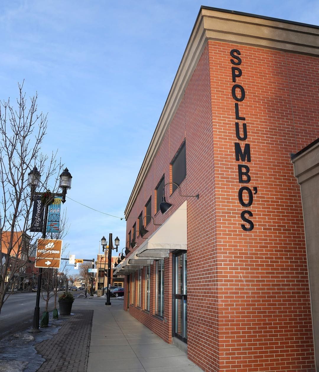 An exterior side-angle of Spolumbo’s, a red-brick building in Calgary’s busy Inglewood neighbourhood.