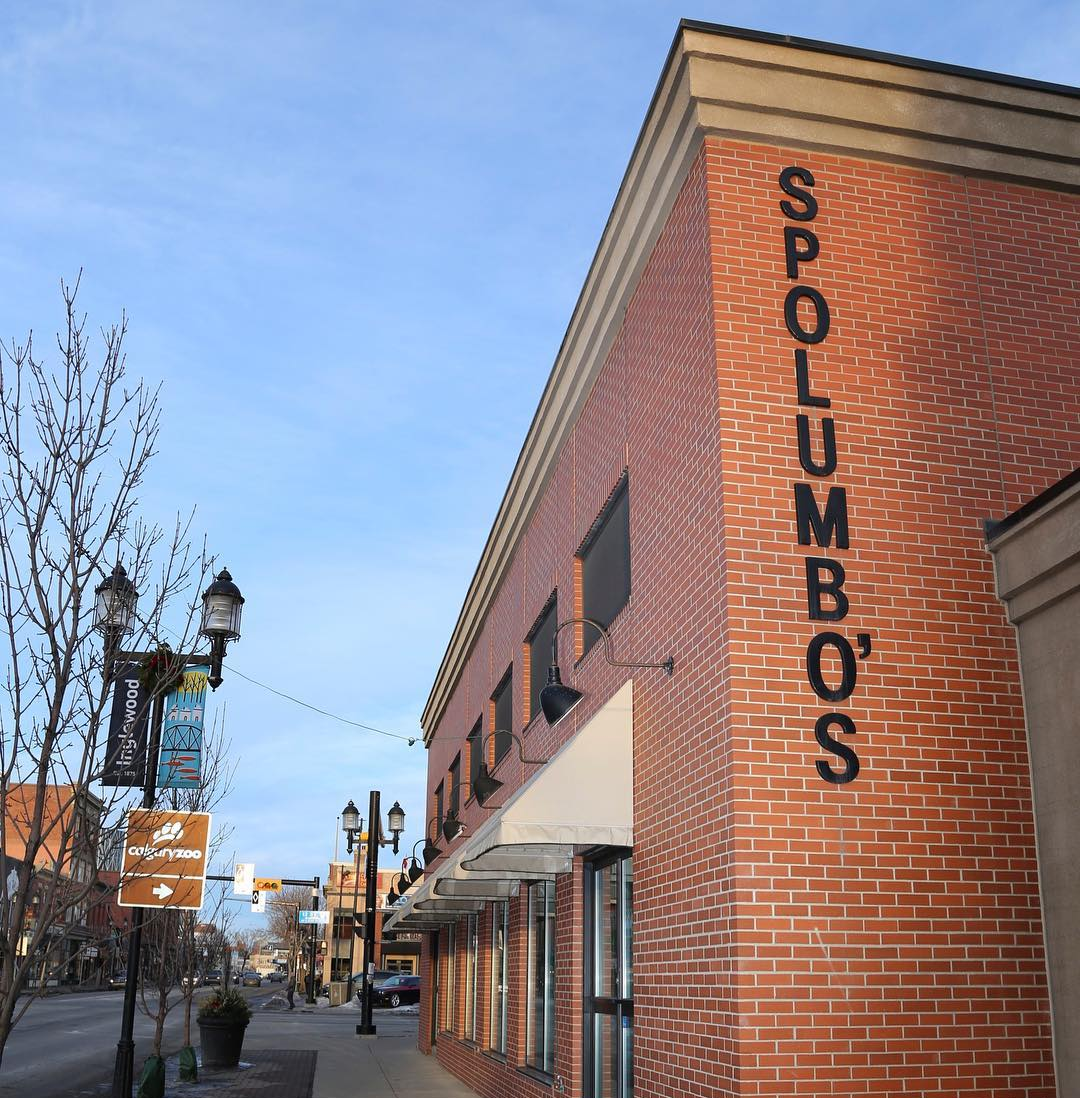 An exterior side-angle of Spolumbo’s, a red-brick building in Calgary’s busy Inglewood neighbourhood.