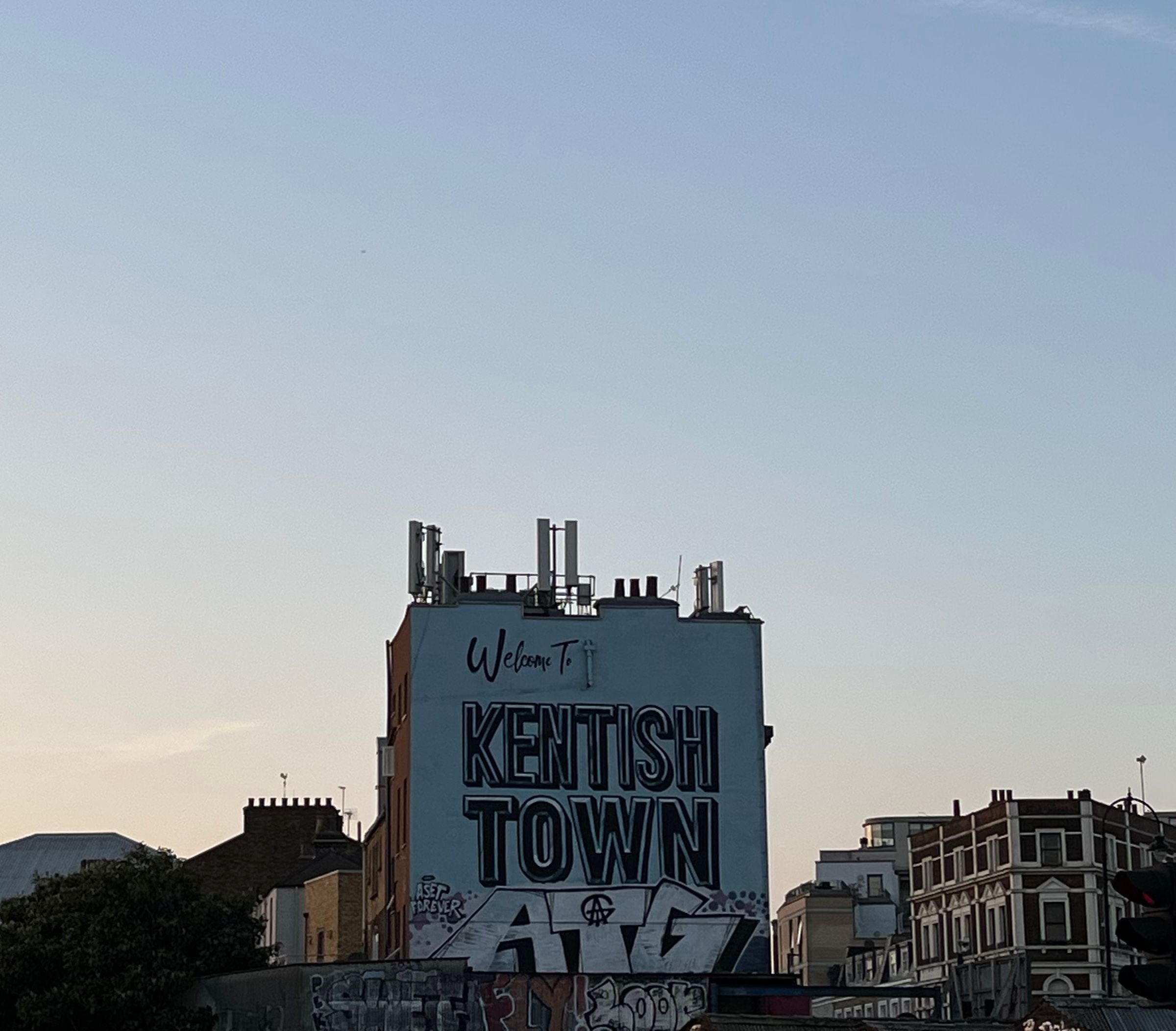 graffiti welcome to kentish town with sunset in backdrop