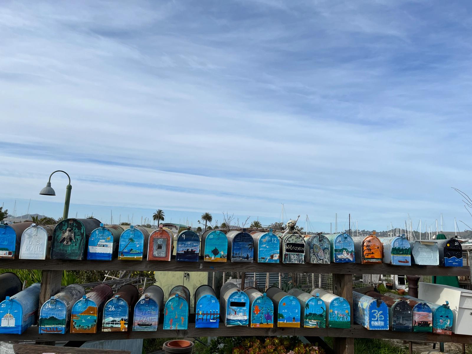 colorful mailboxes against a blue sky
