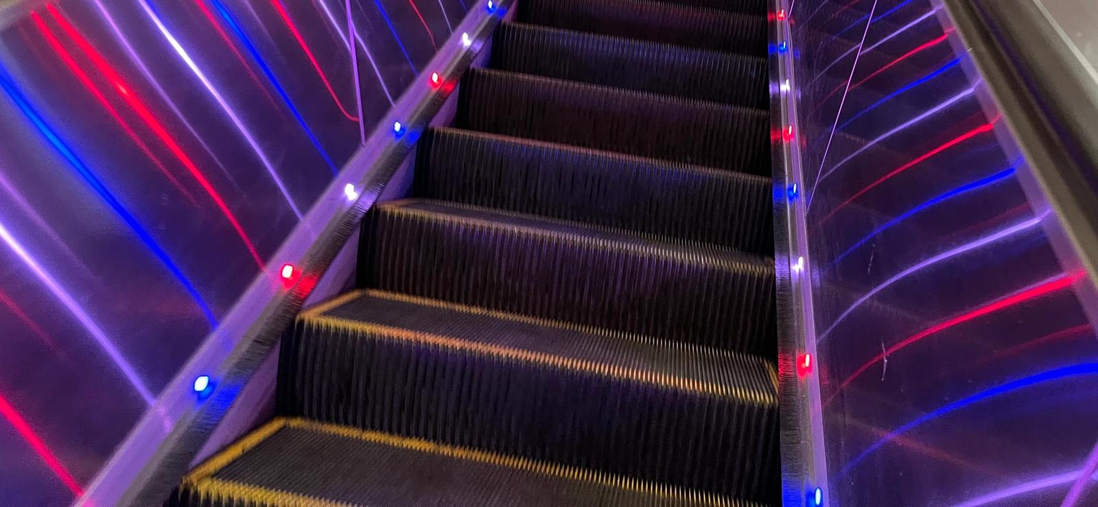 escalator with very colourful lights