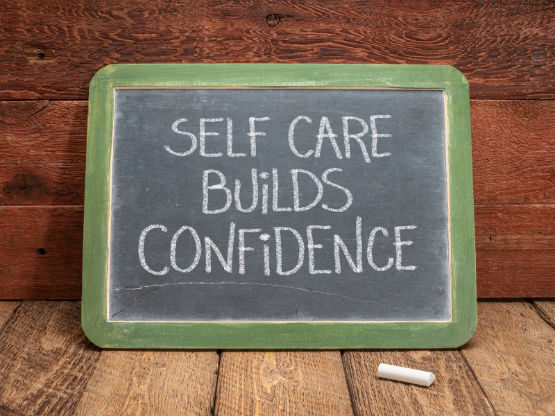 a chalk board that reads self care builds confidence