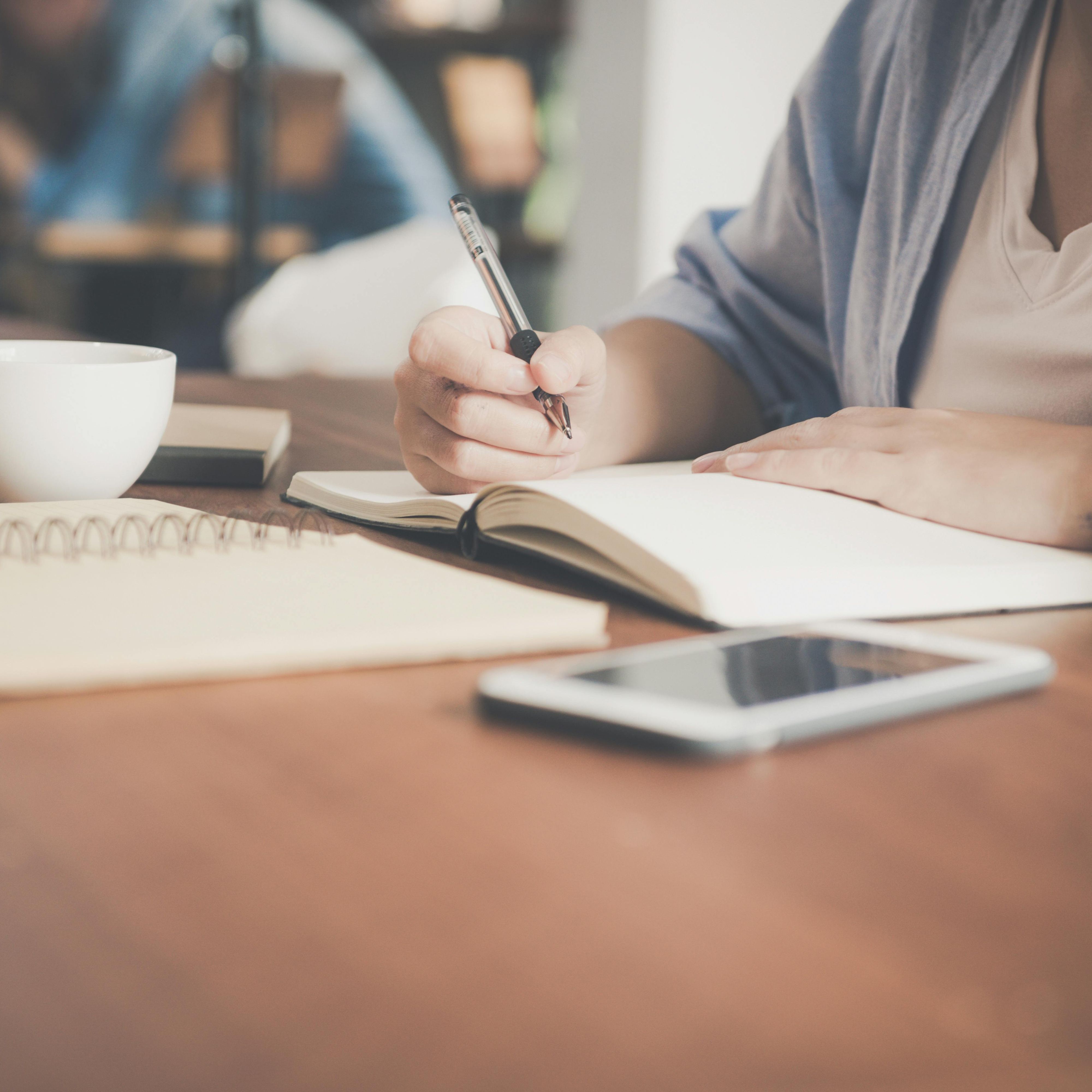Learner at desk writing