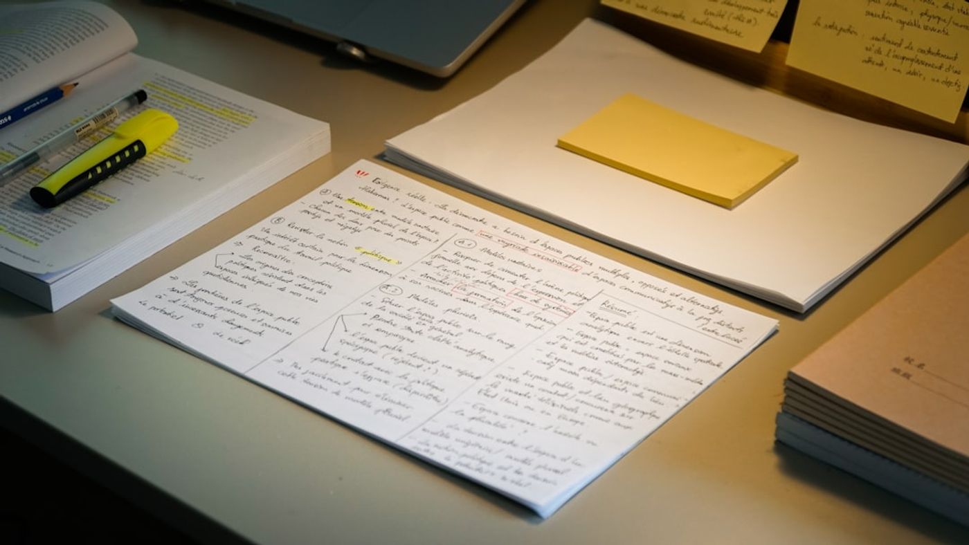 Writer creating a content outline on a laptop with notes and headings
