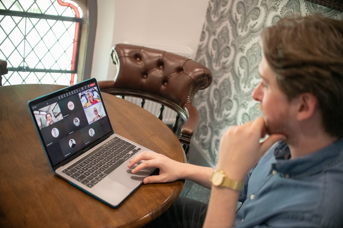Person analyzing community discussion threads on a laptop