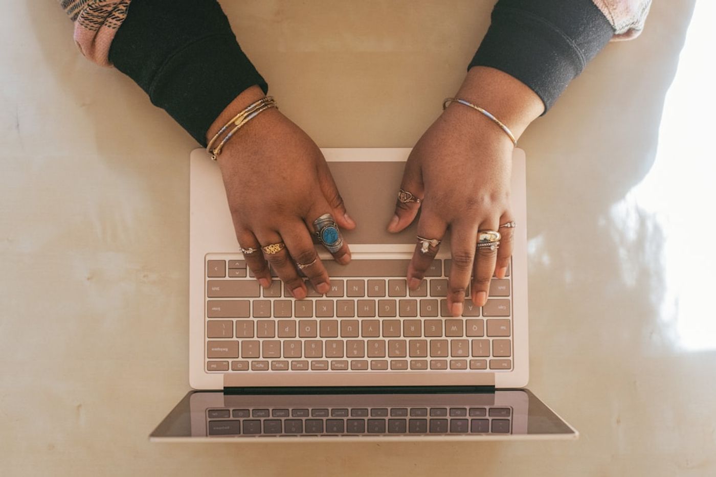 Person typing on laptop with community discussion forum on screen