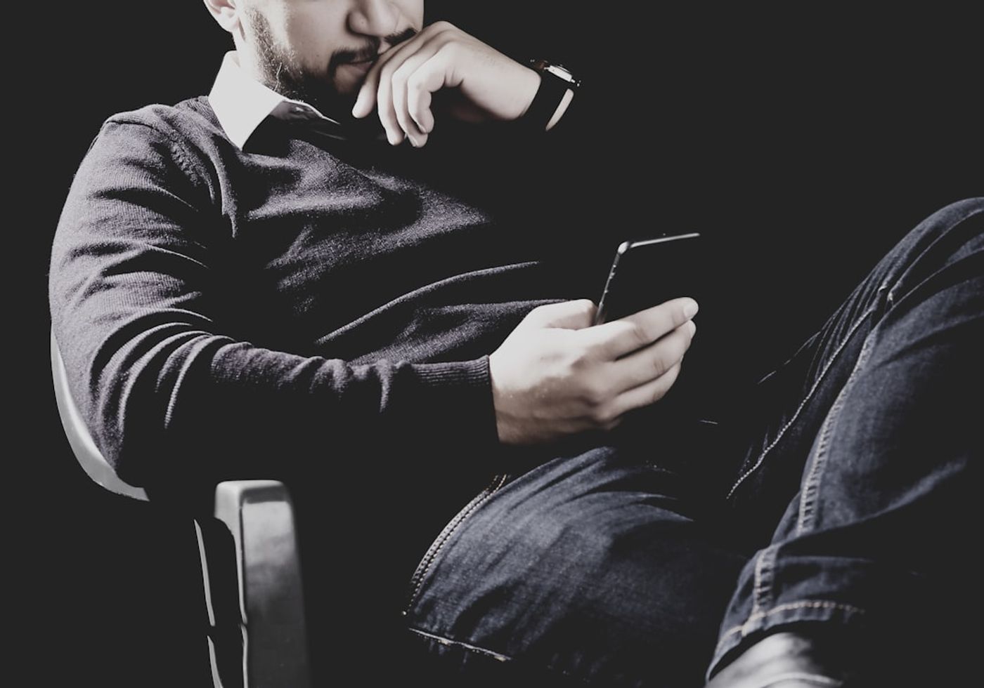 Person scrolling a social media feed on a phone with comment box visible