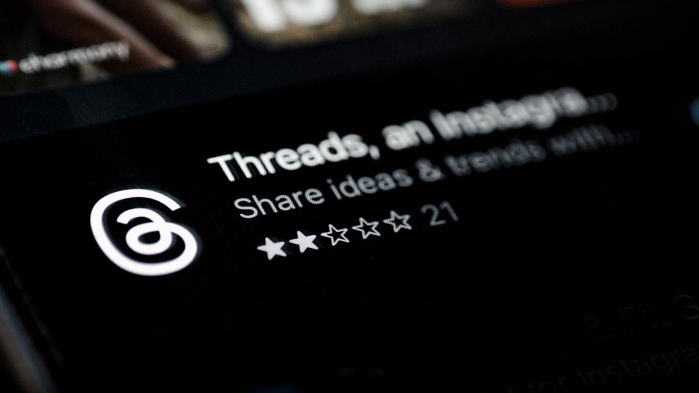 Person reading Reddit threads on a laptop with notes