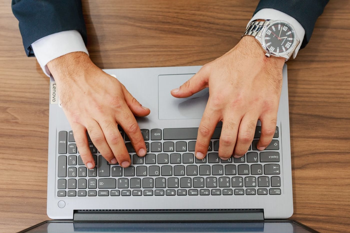 Founder typing on a laptop responding to community questions in a forum setting