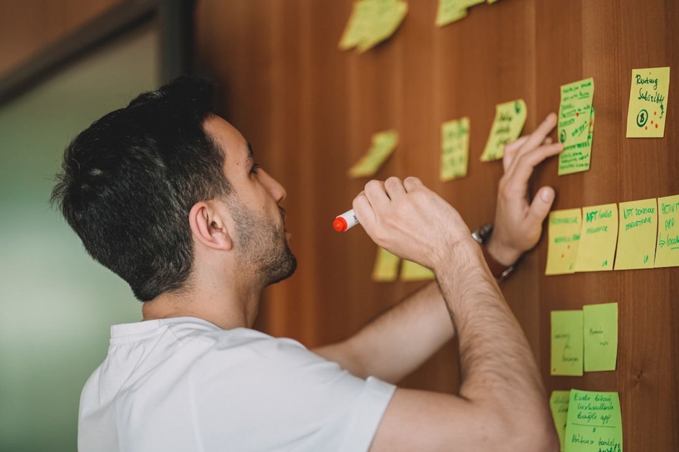 Founder planning a two-week sprint on a whiteboard with a checklist