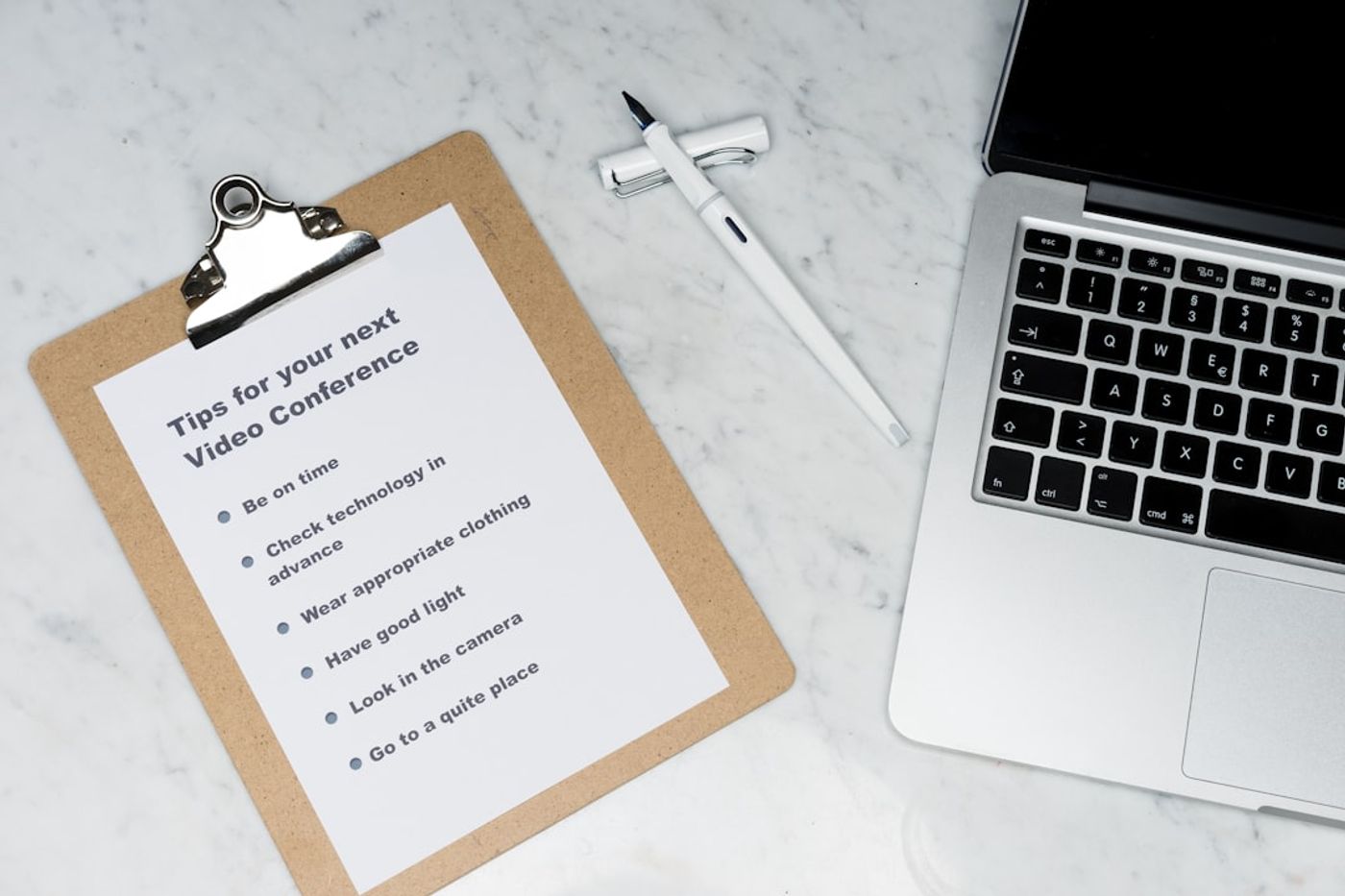 Checklist on paper next to a laptop (content workflow and rules)