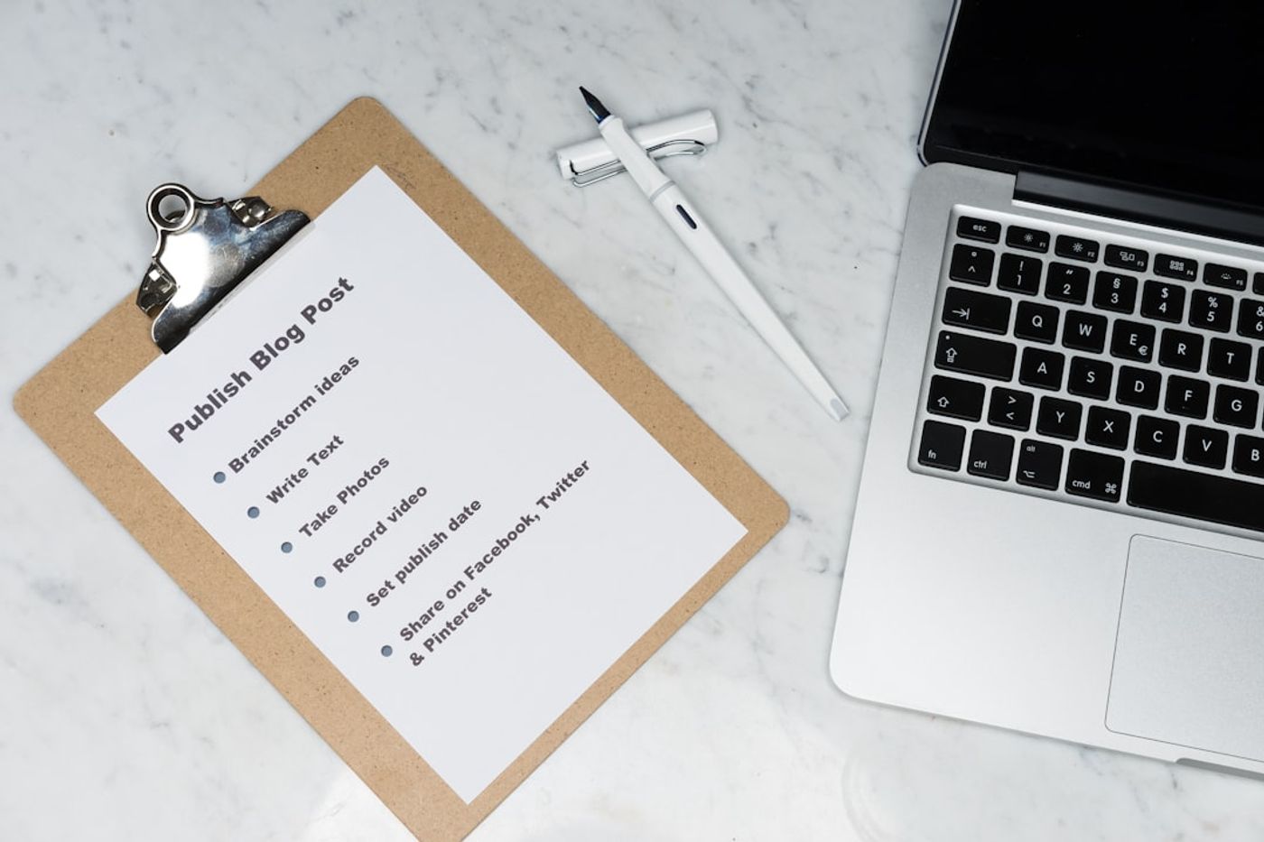 Checklist on a clipboard next to a laptop showing online community guidelines