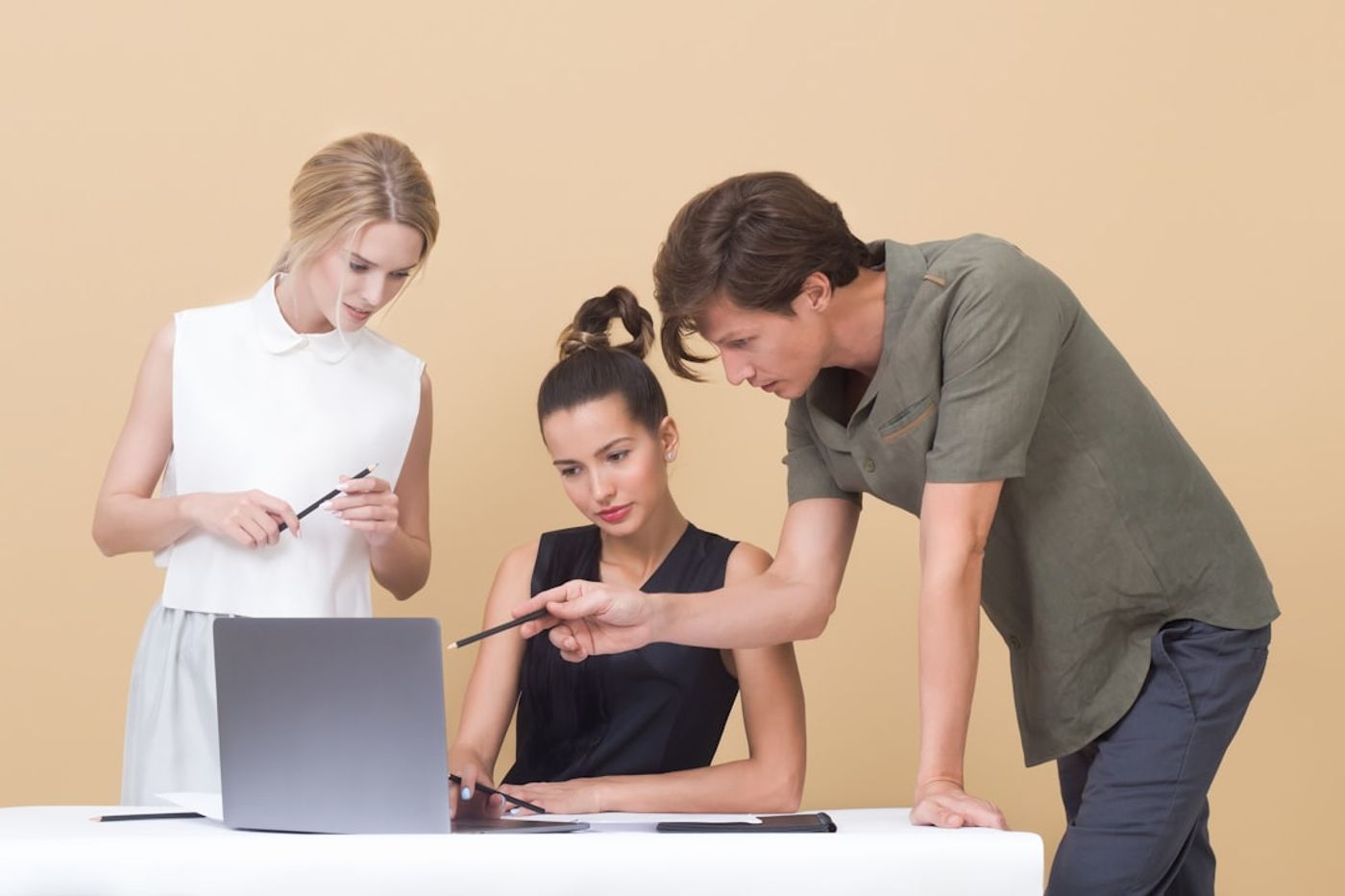 Small team collaborating with a content calendar on a laptop