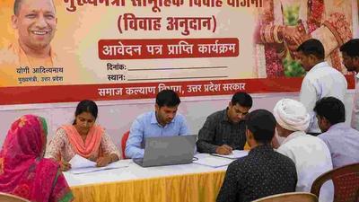 An Indian family checking details of a government marriage assistance scheme before their daughter's wedding.