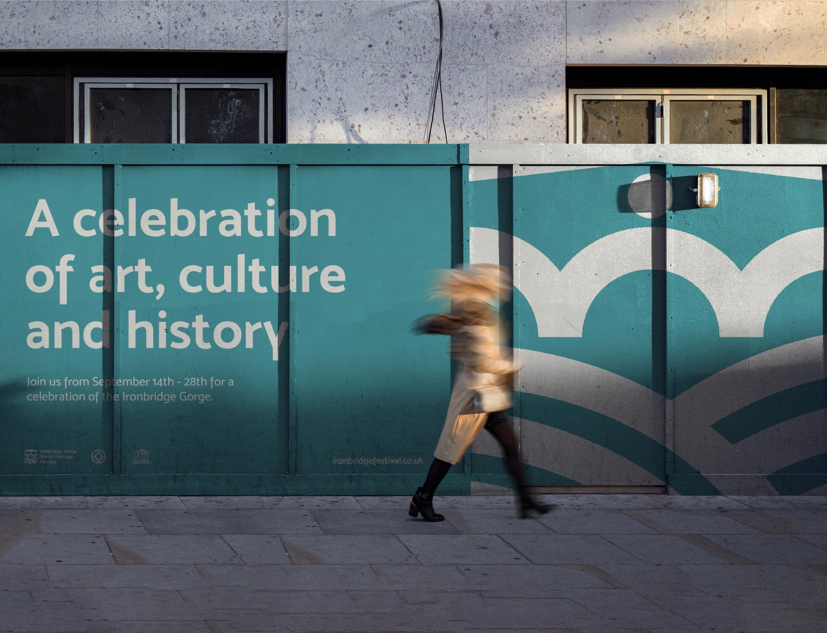 A large mural featuring the Ironbridge Gorge World Heritage Festival branding.
