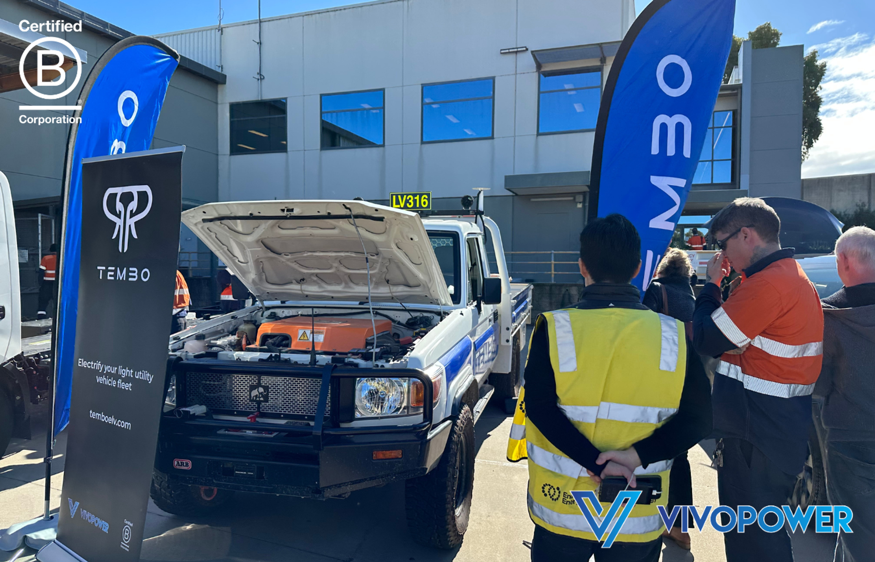 Visitors in hi-vis look under the open bonnet of a Tembo electric Land Cruiser ute at Endeavour Energy’s Future Forum