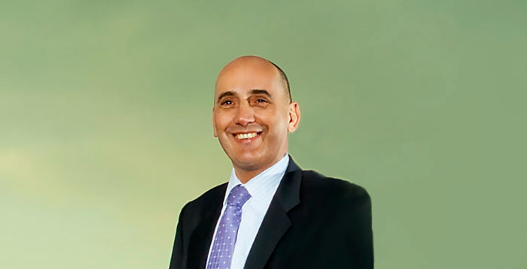 Portrait of Jos van der Linden, Managing Director (Netherlands) of Tembo e-LV, in a dark suit and lilac tie