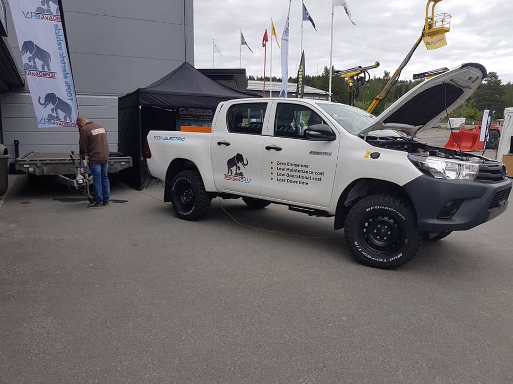 Electric Toyota Hilux dual-cab with bonnet open at the Tembo 4x4 e-LV outdoor stand at Euro Mine Expo in Skellefteå