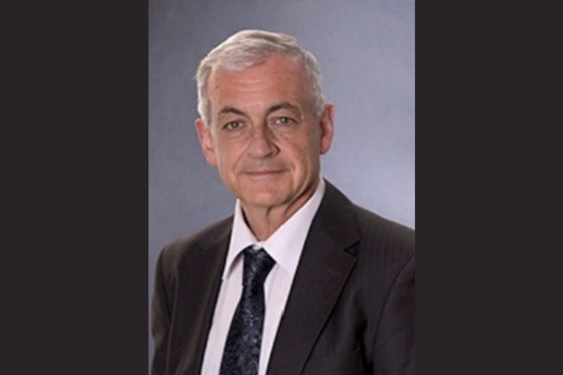 Eduardo Nebot, head-and-shoulders portrait in a dark suit and tie