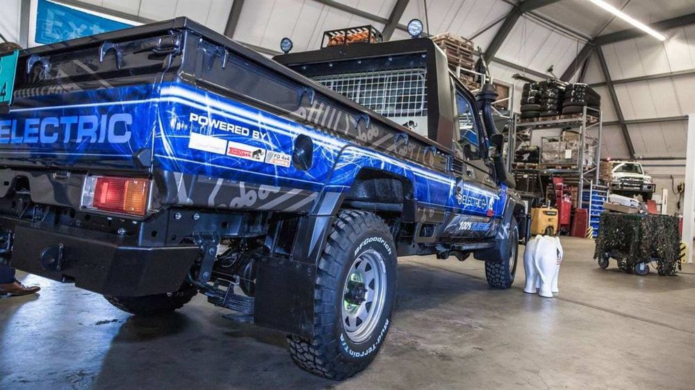Rear view of the Tembo 4x4 Electric Cruiser ute in a warehouse, with a white elephant statue beside it