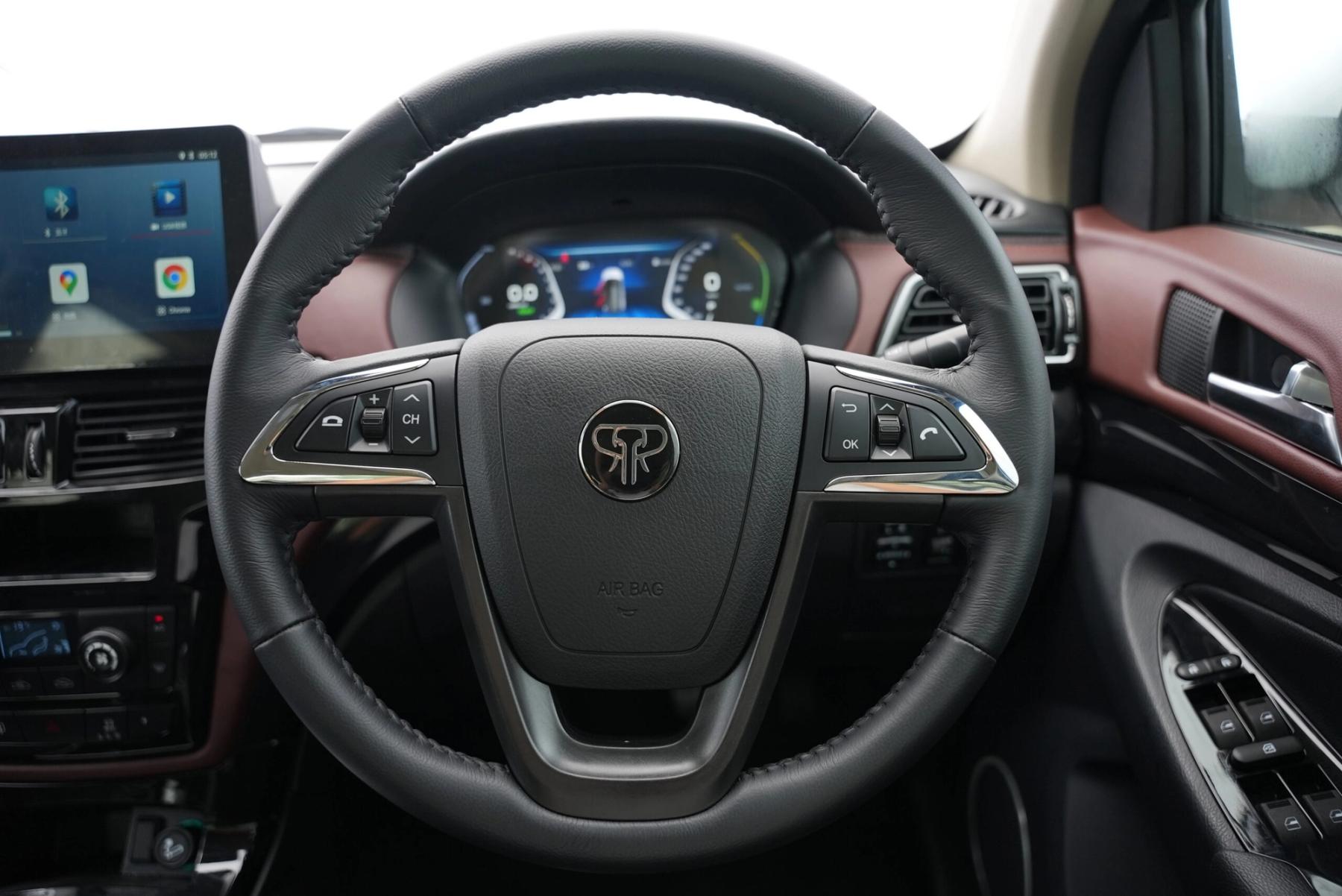 Steering wheel with Tembo badge, digital instrument cluster and touchscreen inside a right-hand-drive Tembo Tusker