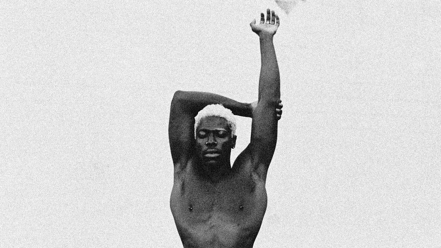 A top-less Moses poses with arms outstretched above his head.
