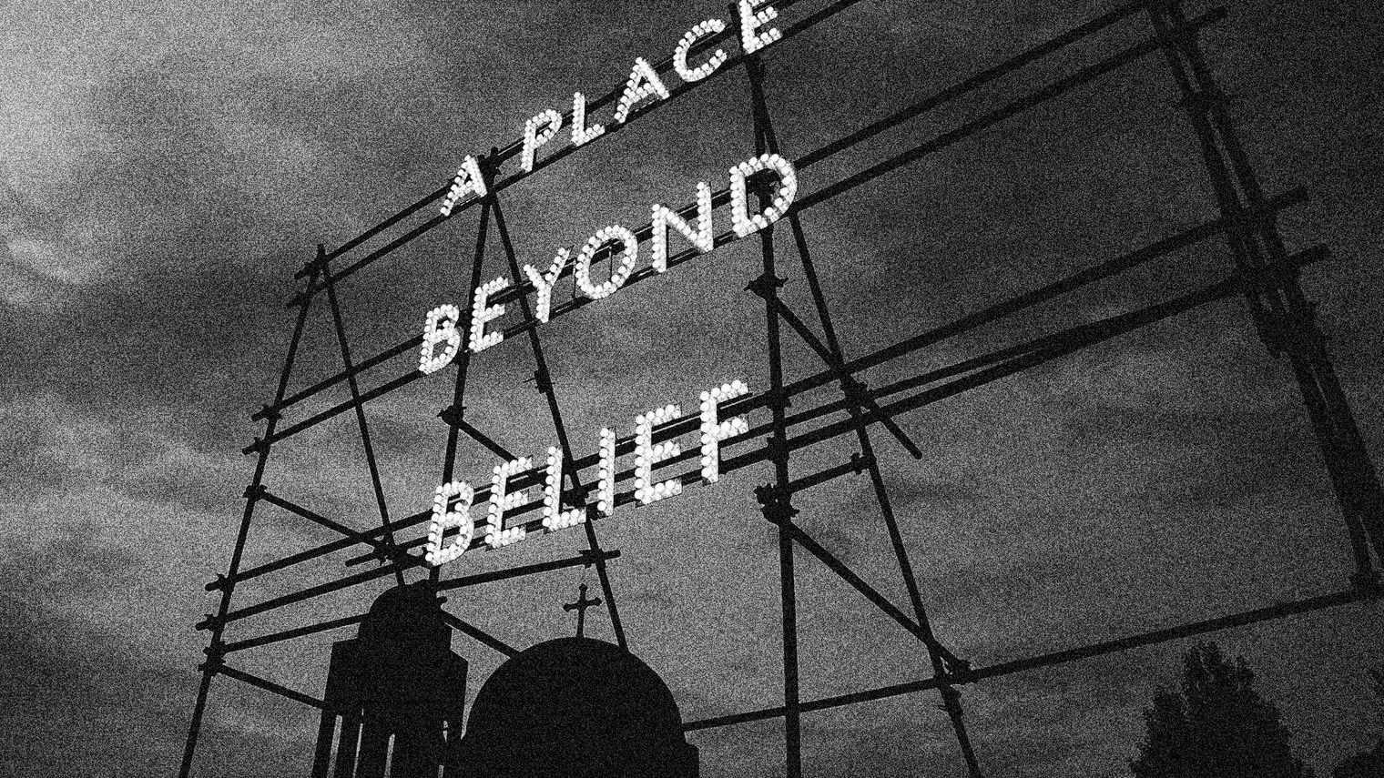 A neon sign mounted to scaffolding reads "A place beyond belief".
